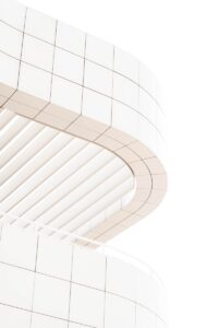 a white building with a clock on the side of it